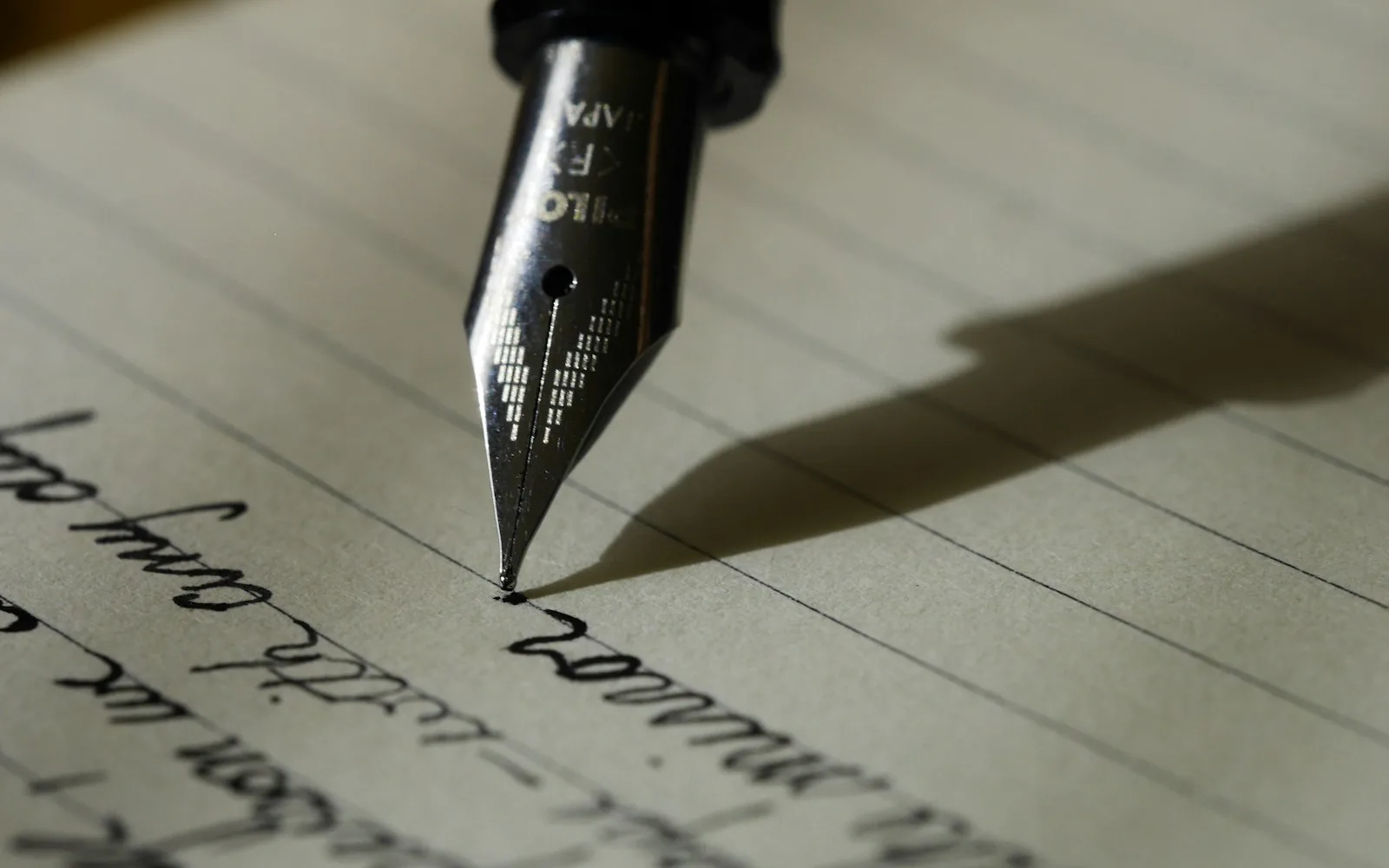 A notebook and pen on a desk used to plan a hiring workflow