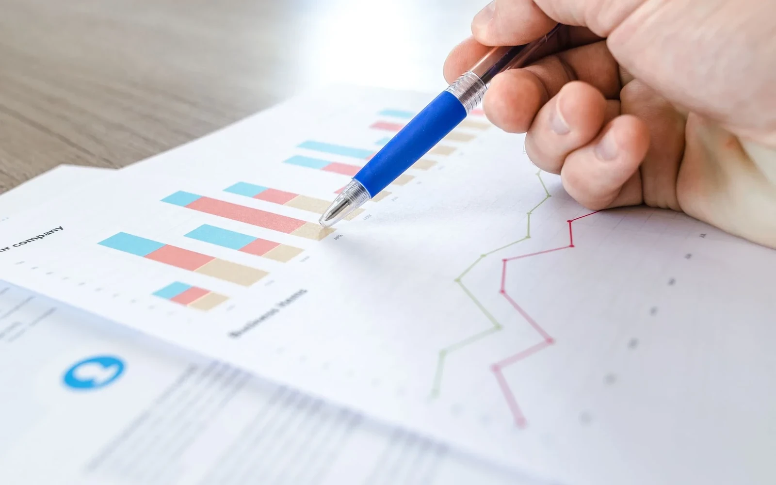 A printed chart being reviewed with a blue pen