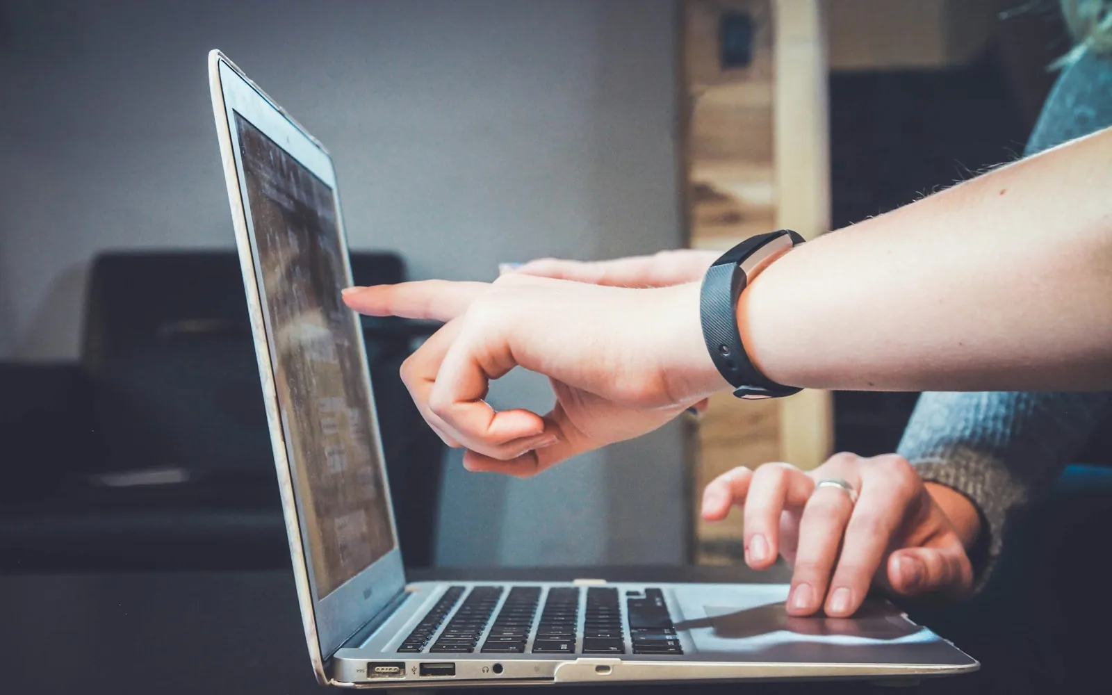 A recruiter following up with a candidate on a laptop