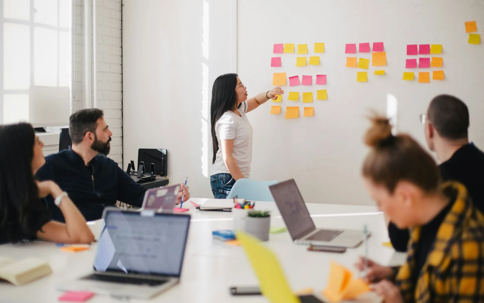 A team mapping hiring handoffs and candidate stages on a workshop wall